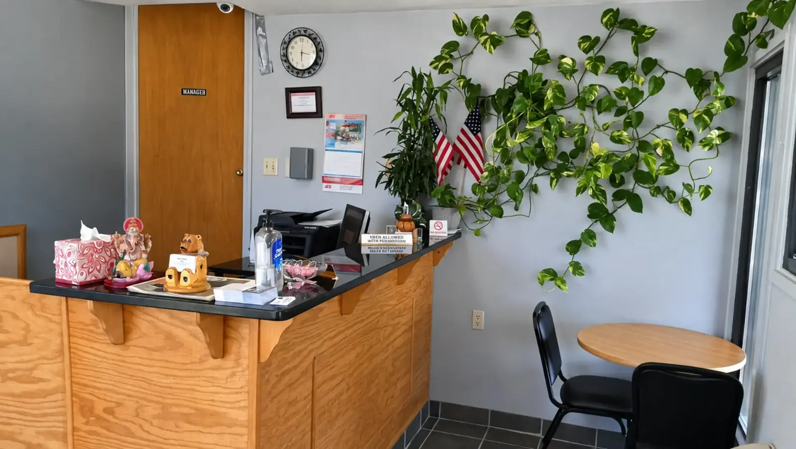 Bestway Inn reception counter and lobby seating with indoor plants